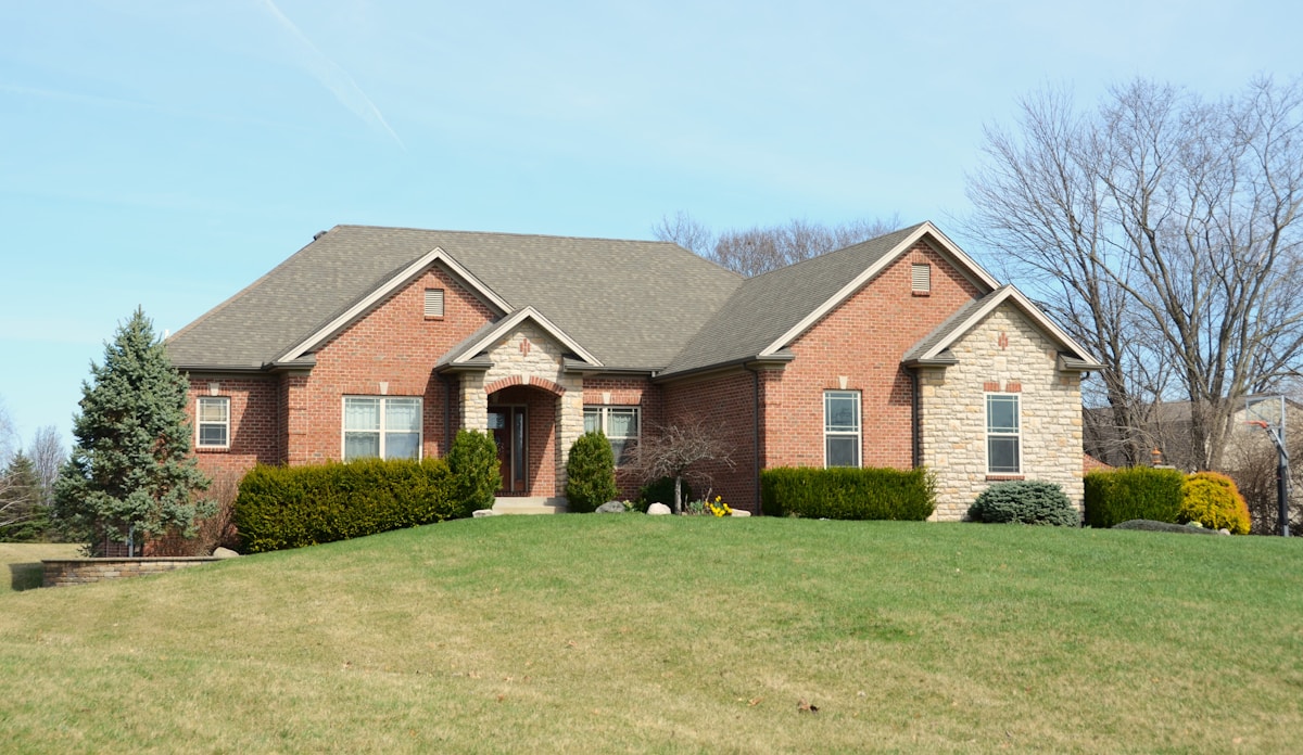 Traditional brick house exterior with manicured lawn